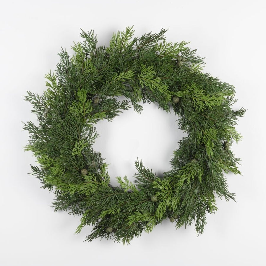 A round green wreath made of cedar branches.