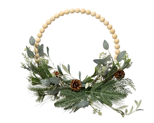 A wreath made with wooden balls, pinecones, and eucalyptus leaves with a glittery finish.