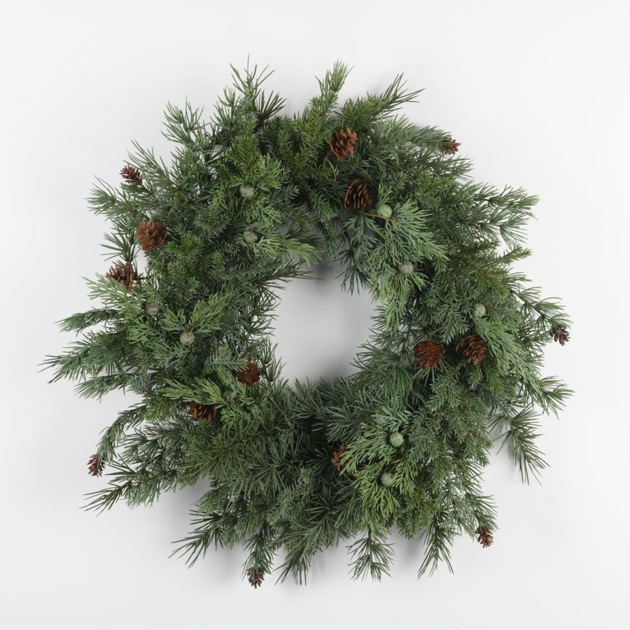 A green wreath with cedar and cones, approximately 60cm in diameter, displayed against a white background.