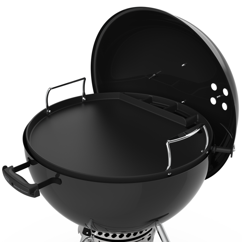 Weber Full-Size Griddle sitting in a Weber Master-touch charcoal BBQ