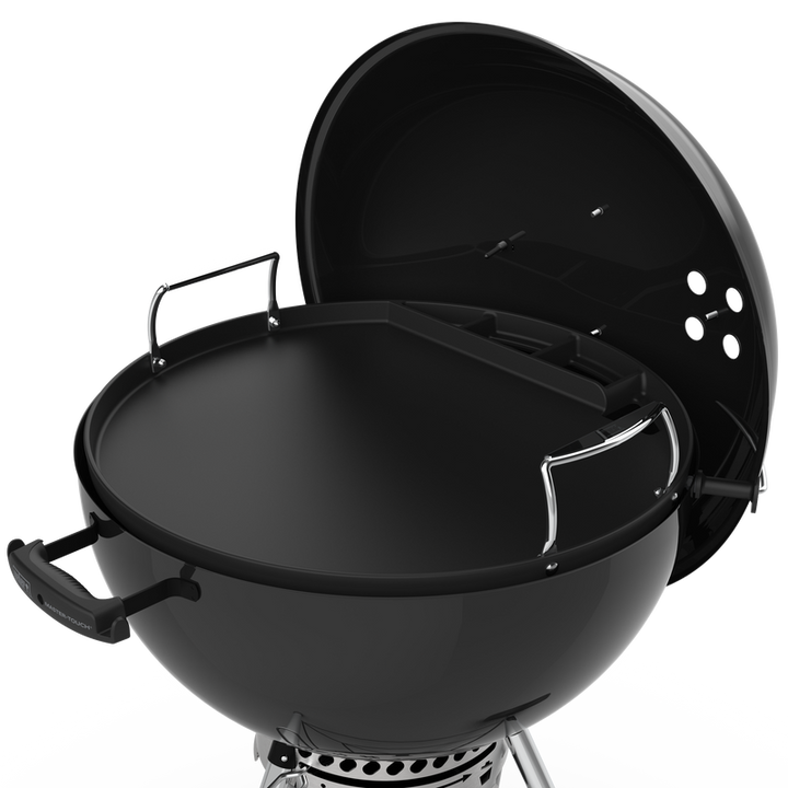 Weber Full-Size Griddle sitting in a Weber Master-touch charcoal BBQ