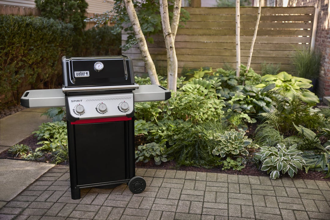 Weber Spirit E-310 Gas BBQ in a garden