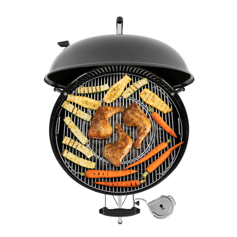 food sitting on grill grates on a Weber Master-Touch E-5750 barbecue