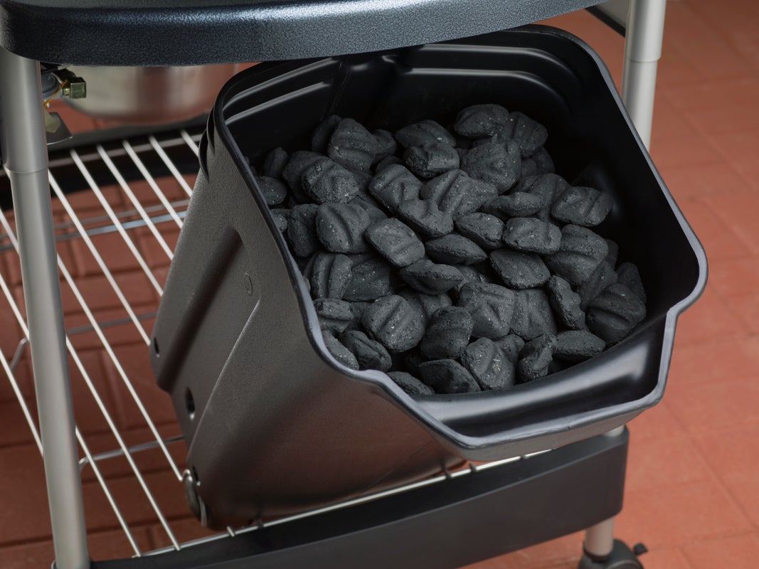 Charcoal in a bin from a Weber Performer Deluxe Barbecue