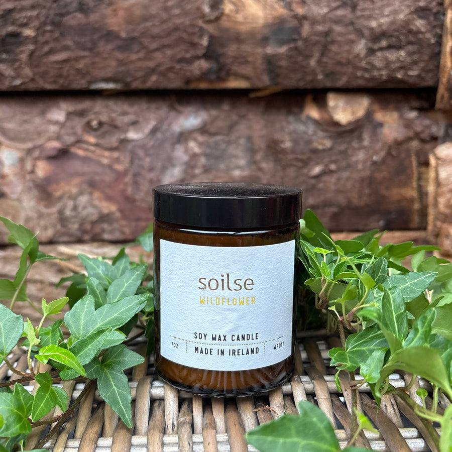 Soilse Wildflower Apothecary Amber Jar Candle featuring peony, red apple, and jasmine scent notes