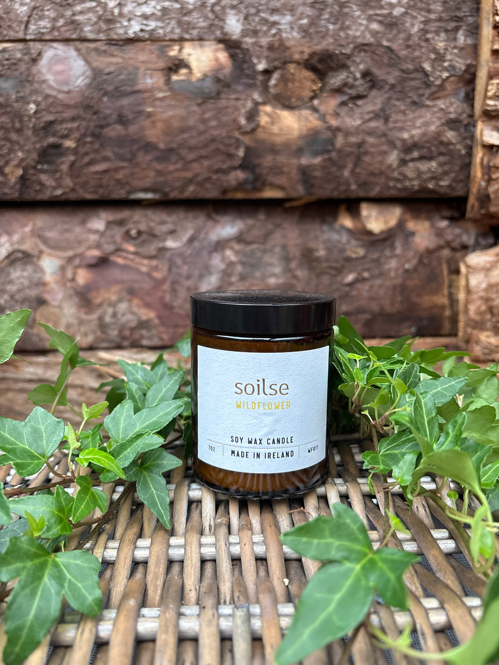 Soilse Wildflower Apothecary Amber Jar Candle featuring peony, red apple, and jasmine scent notes