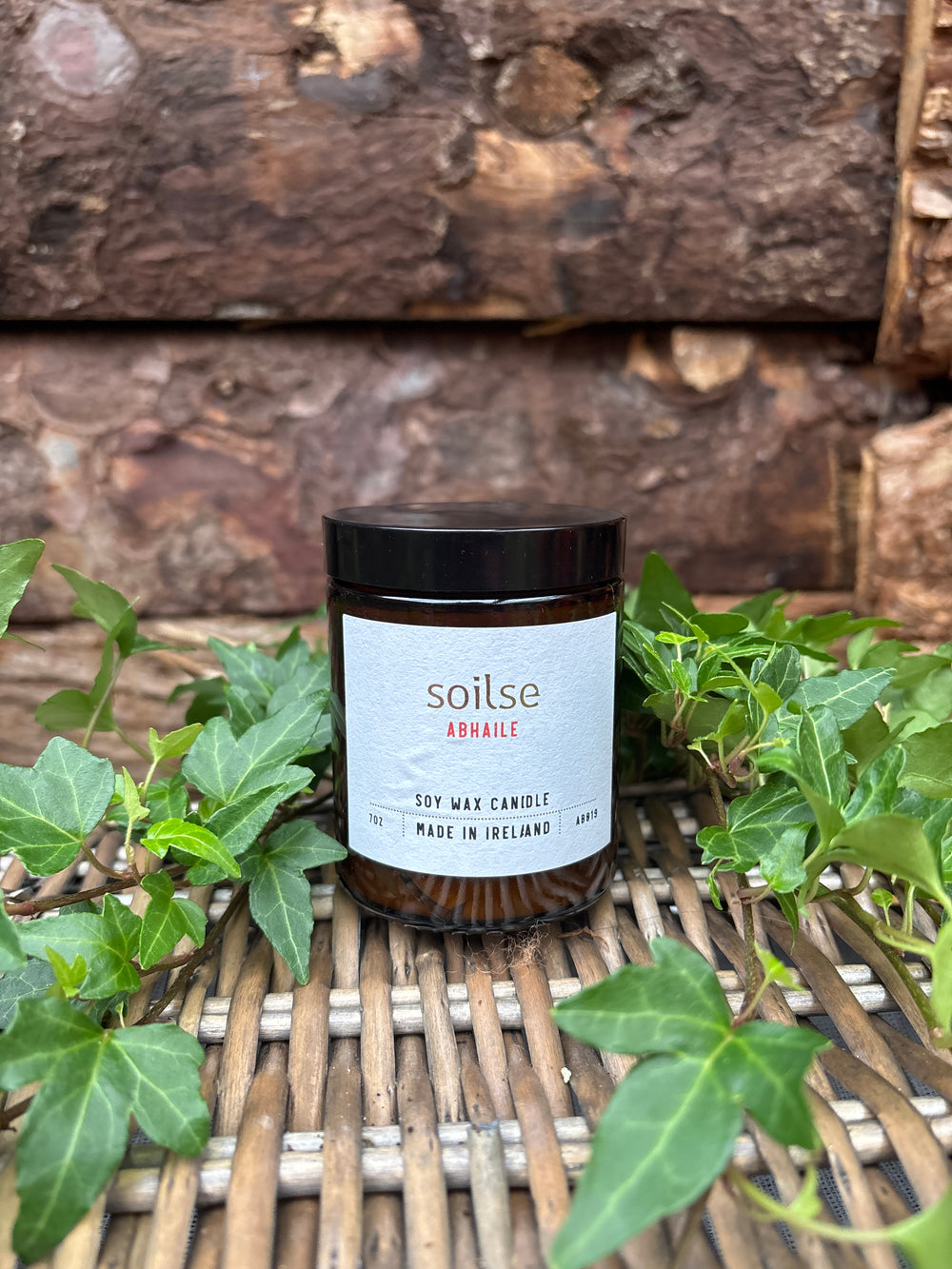 Soilse Homecoming Apothecary Amber Jar Candle with garden floral, honey, and tobacco scent notes