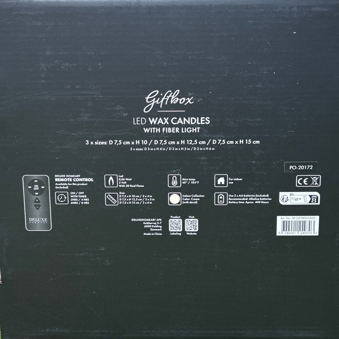 Black box with text on a woven surface and green grass background