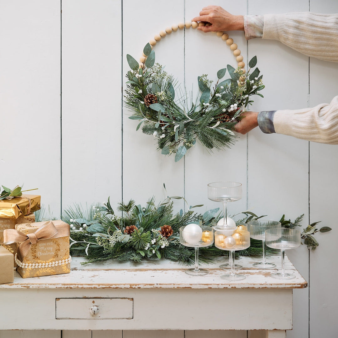 Modern green Christmas wreath with glitter wooden balls, pinecones and eucalyptus, alternate view