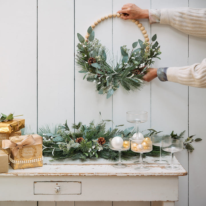 Modern green Christmas wreath with glitter wooden balls, pinecones and eucalyptus, alternate view