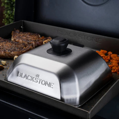 Blackstone grill Cloche lid on a grill with food cooking underneath