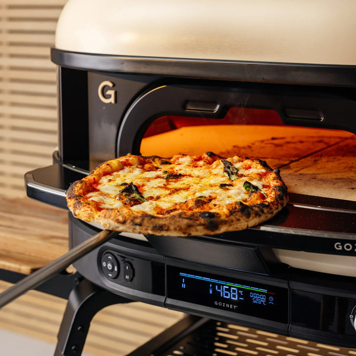 Gozney pizza oven with a freshly baked pizza inside