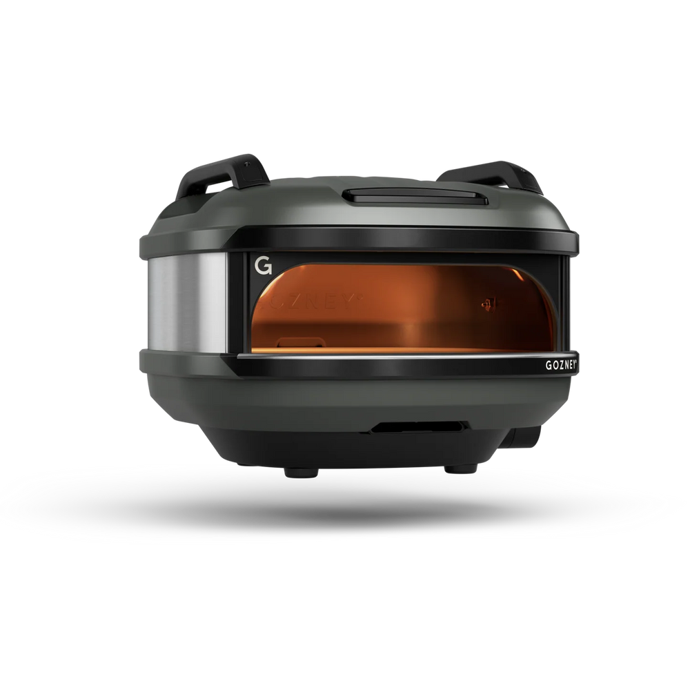 A GOZNEY outdoor pizza oven with a dark gray and black finish, featuring a silver side panel and a glowing amber-orange glass front window, shown on a white background with a soft shadow.