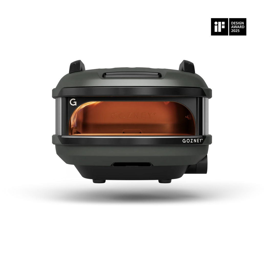 A Gozney portable oven shown from the front on a clean white background, featuring a dark gray exterior and a glowing amber-orange interior. An 'iF Design Award 2023' badge is visible in the top right corner.