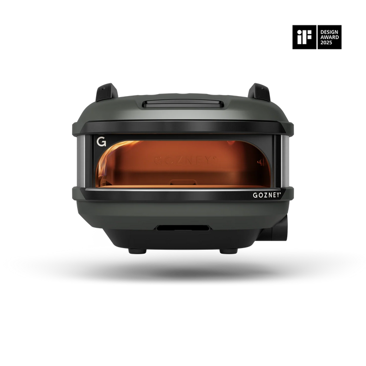 A Gozney portable oven shown from the front on a clean white background, featuring a dark gray exterior and a glowing amber-orange interior. An 'iF Design Award 2023' badge is visible in the top right corner.