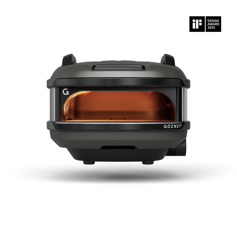 A Gozney portable oven shown from the front on a clean white background, featuring a dark gray exterior and a glowing amber-orange interior. An 'iF Design Award 2023' badge is visible in the top right corner.