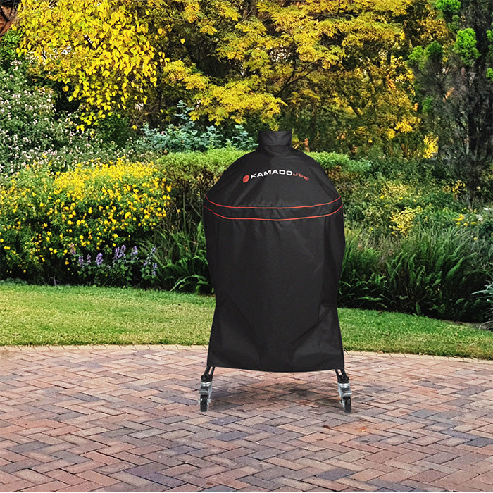 Black Kamado Joe Big Joe grill cover protecting a kamado barbecue on a patio