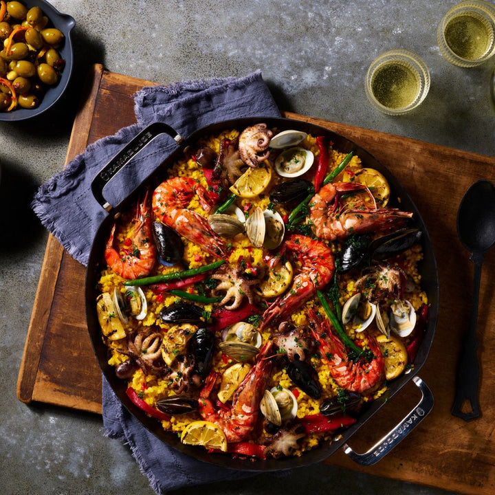 Top view of a Kamado Joe Karbon Steel Paella Pan cooking paella