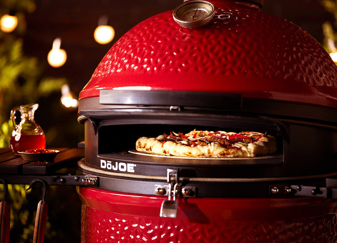 Pizza cooking in a DōJoe insert inside the Kamado Joe Big Joe III