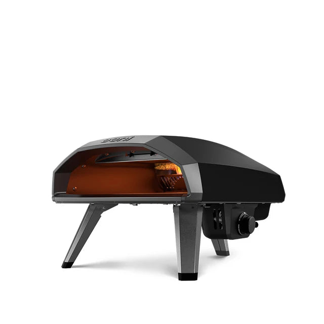 Black Ooni Koda 2pizza oven with glowing interior on a white background