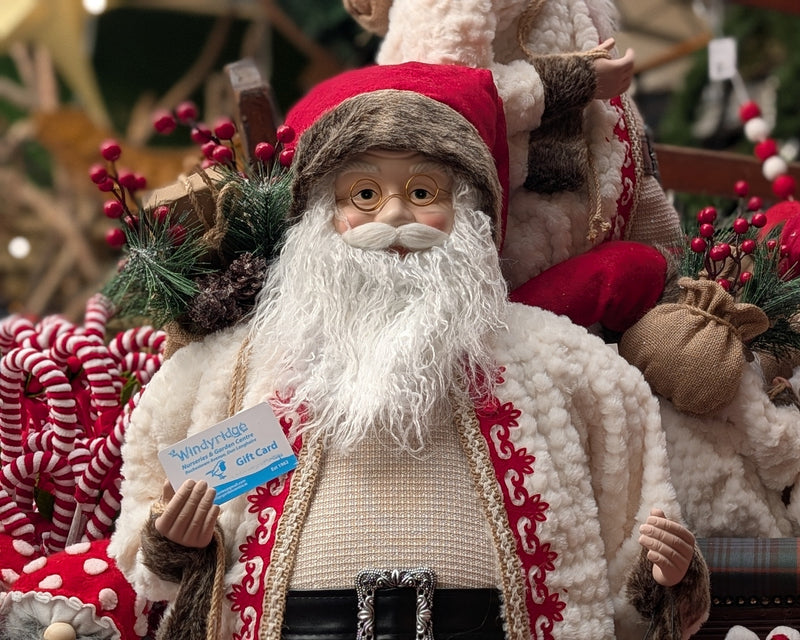 Decorative Santa Claus figure with a blurred Christmas market background