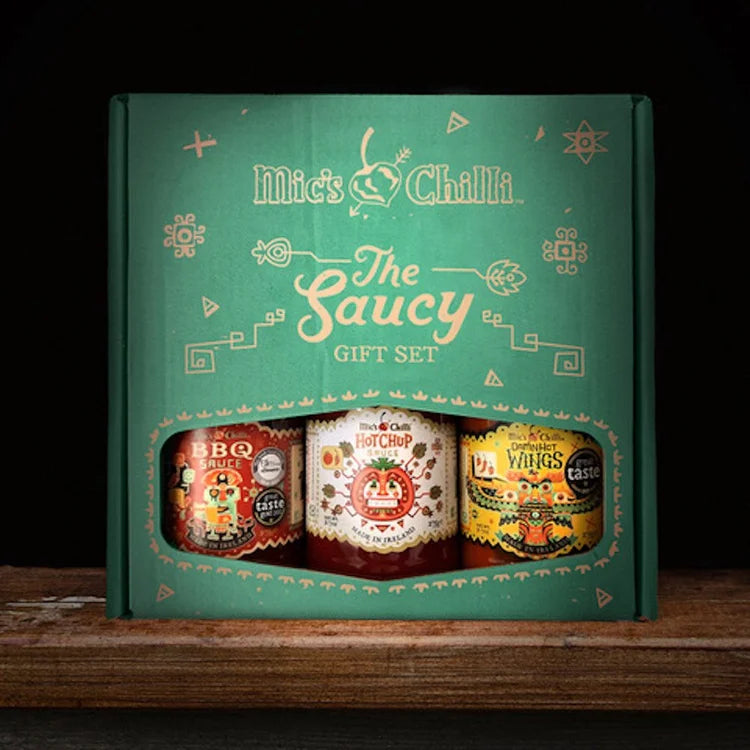 Mick's Chilli saucy gift set packaging on a wooden surface with a dark background