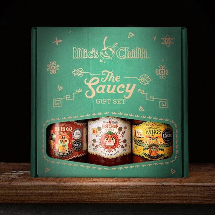 Mick's Chilli saucy gift set packaging on a wooden surface with a dark background