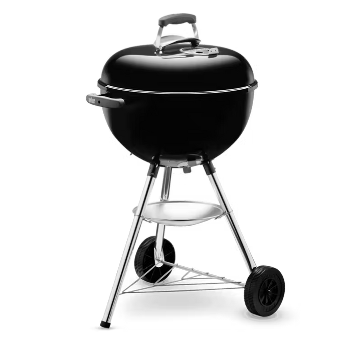Black Weber kettle grill on wheels with a transparent background