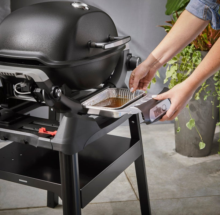 pulling out a great tray on a Q1200N Grill