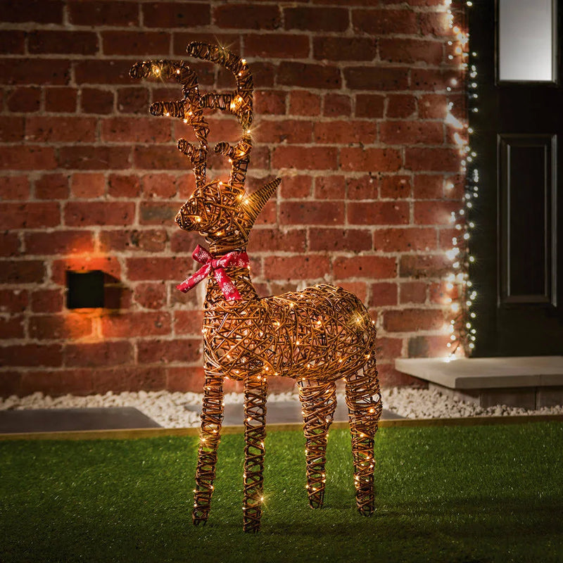 Decorative reindeer with lights against a brick wall