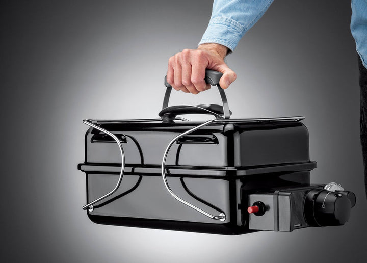 Man carrying a Weber Go Anywhere Gas BBQ